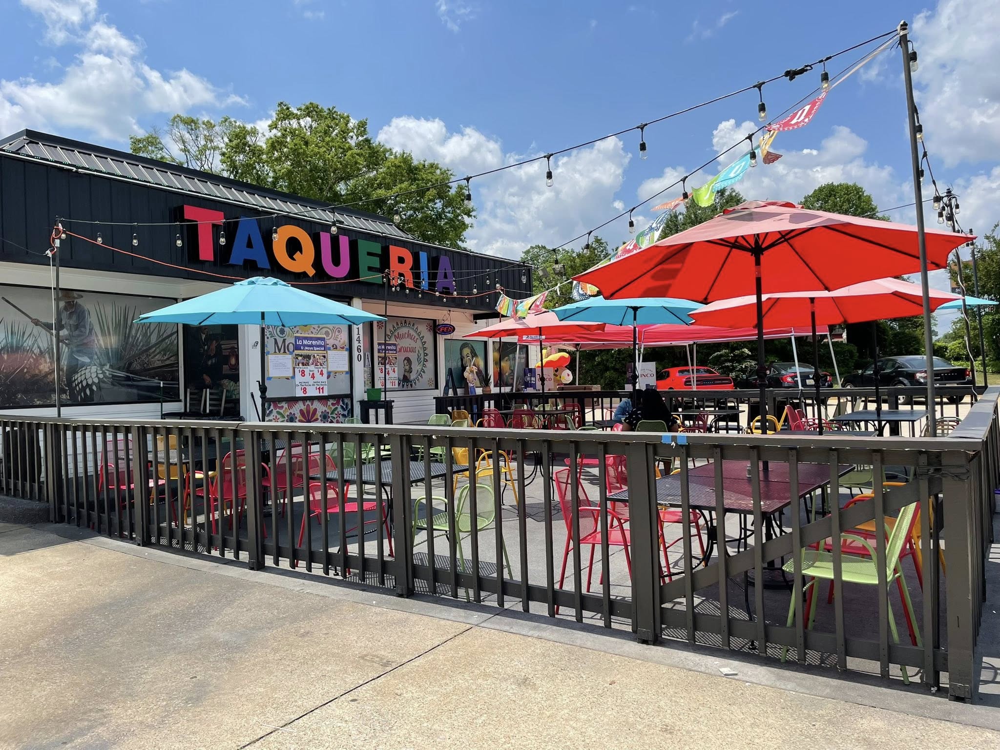 La Morenita’s colorful Taqueria sign, red umbrellas, and outdoor patio in Auburn